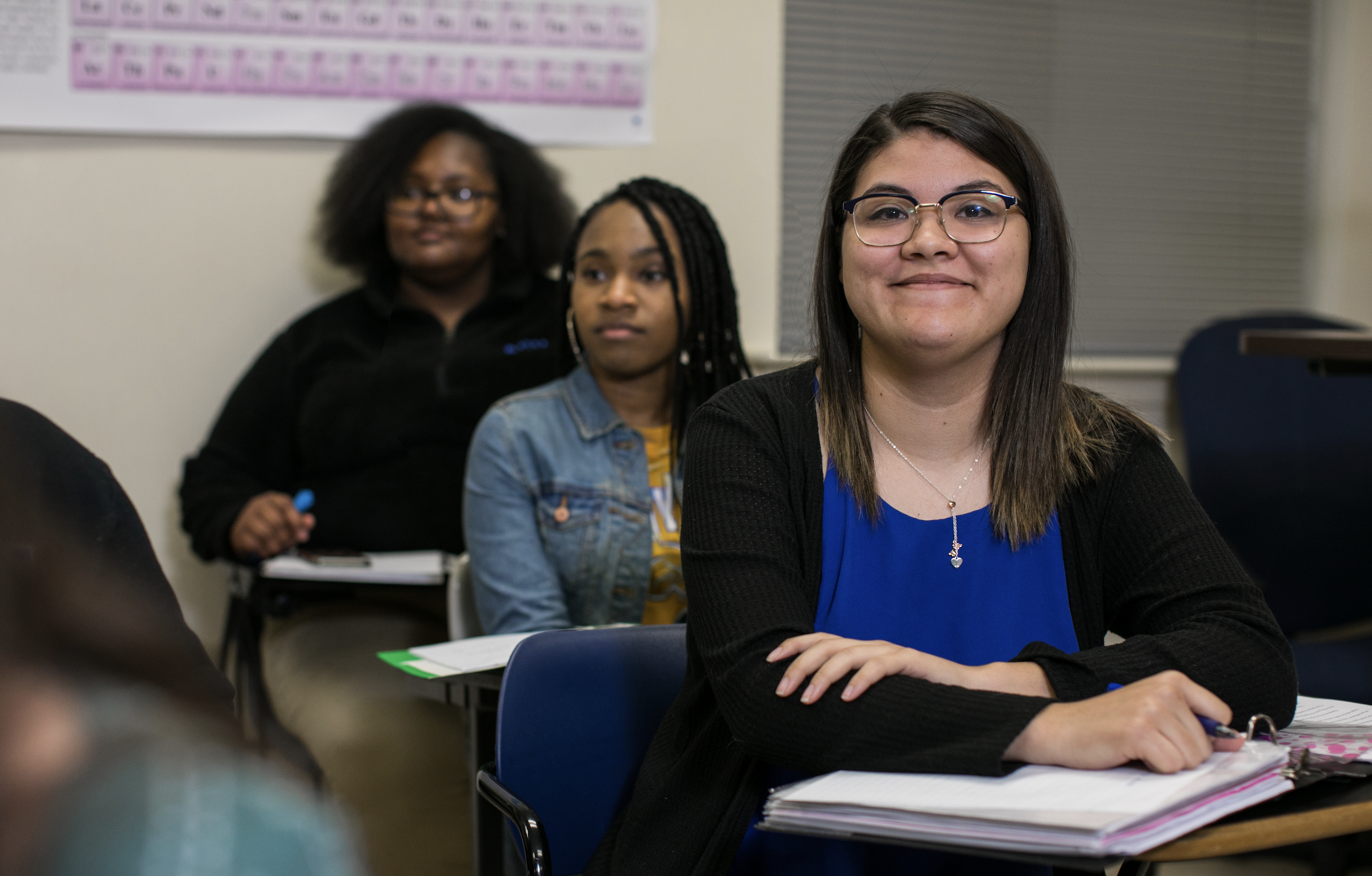 Student studying and smiling